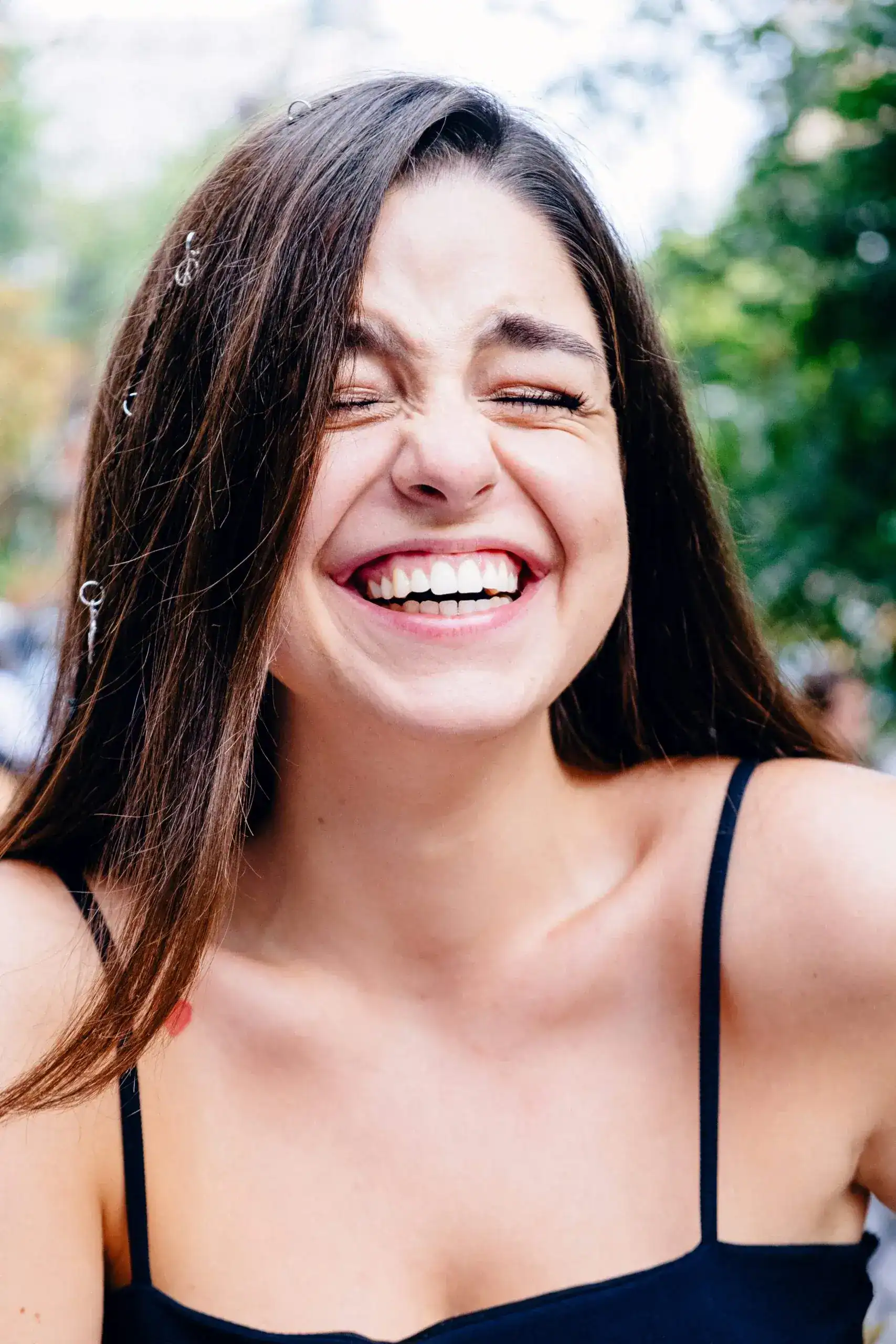 Zubkov Dental Smile Best Dentist Smiling woman with long hair showcasing a bright smile, emphasizing dental health and patient satisfaction at Zen Dental.