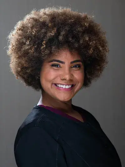 Dental assistant Haney smiling, showcasing her vibrant personality and commitment to patient care at Zen Dental, with a focus on making patients feel safe and improving their smiles.