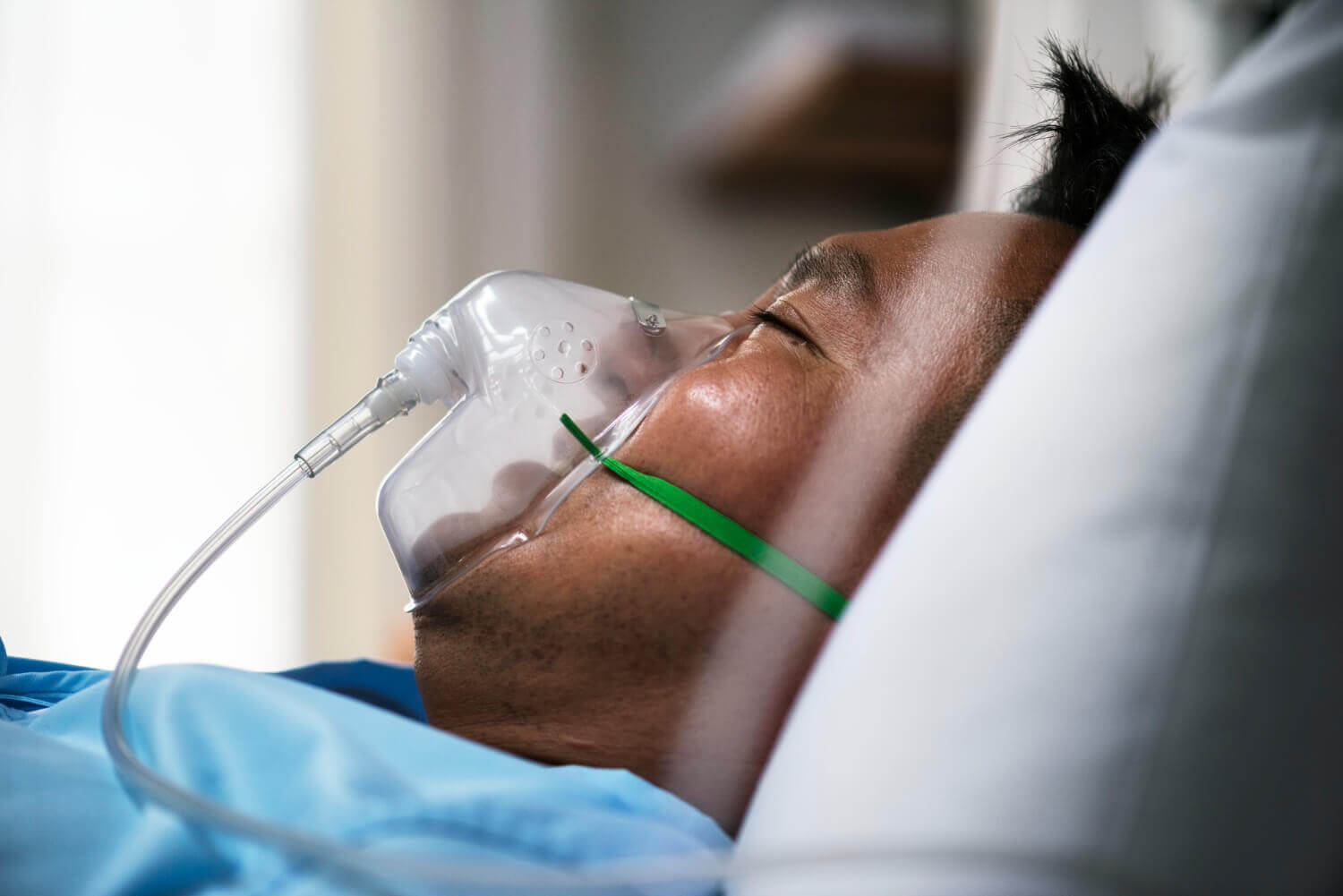 CPAP Patient using CPAP machine for sleep apnea treatment, wearing a mask and connected to oxygen tubing, promoting restful sleep and health improvement.
